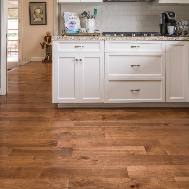 Kitchen with white cabinets and wooden flooring