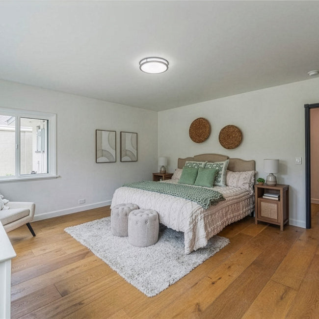 Neatly arranged bedroom with a bed, side tables, and decor.